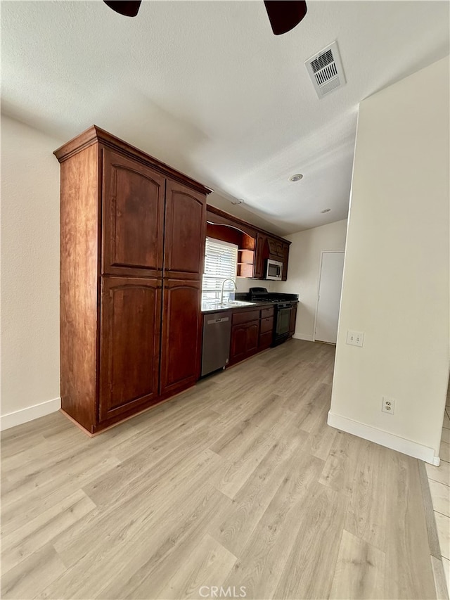 1350 William Mcgrath St, Colton, CA 92324 - kitchen with stainless steel appliances, light wood-style floors, ceiling fan, and open shelves