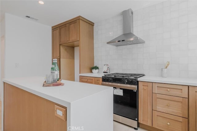 200 N Alberta Pl, Fullerton, CA 92833 - kitchen with stainless steel gas stove, wall chimney range hood, tasteful backsplash, and light countertops