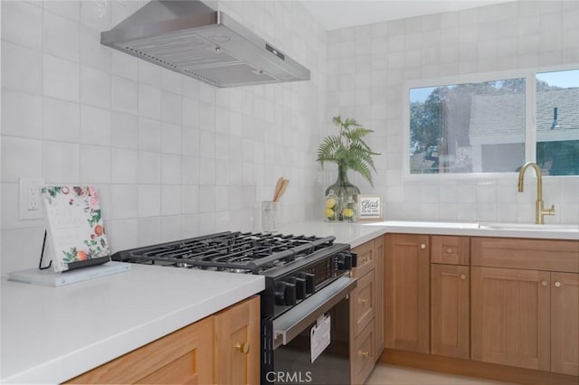 200 N Alberta Pl, Fullerton, CA 92833 - kitchen with ventilation hood, black gas range, decorative backsplash, and light countertops