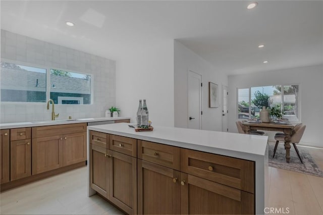 200 N Alberta Pl, Fullerton, CA 92833 - kitchen with light countertops, recessed lighting, brown cabinetry, tasteful backsplash, and light wood-style flooring