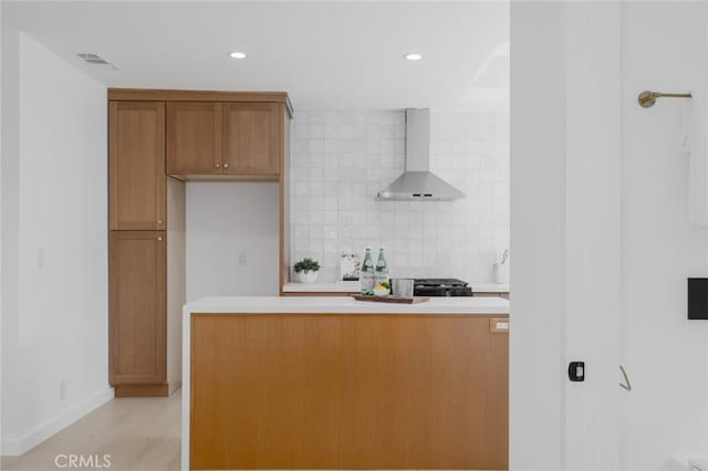 200 N Alberta Pl, Fullerton, CA 92833 - kitchen featuring wall chimney exhaust hood, backsplash, light countertops, brown cabinets, and recessed lighting
