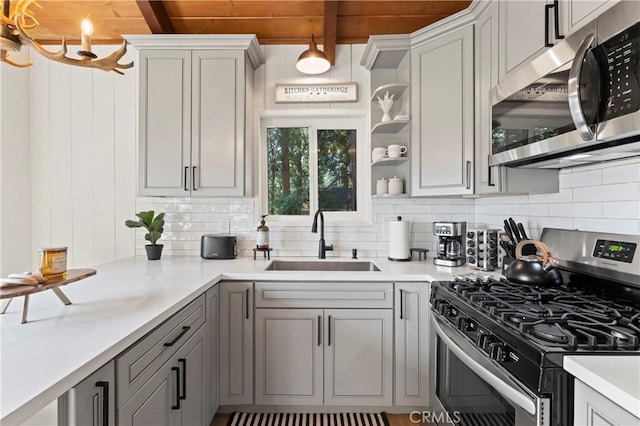 698 W Victoria Ct, Lake Arrowhead, CA 92352 - kitchen featuring appliances with stainless steel finishes, tasteful backsplash, gray cabinetry, light countertops, and a wooden ceiling with exposed beams