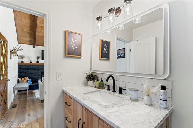 698 W Victoria Ct, Lake Arrowhead, CA 92352 - bathroom with vanity, wood finished floors, tasteful backsplash, and wood ceiling