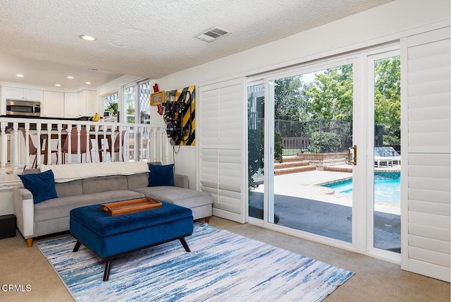 18845 Braemore Rd, Porter Ranch, CA 91326 - living room featuring light carpet, a textured ceiling, and recessed lighting
