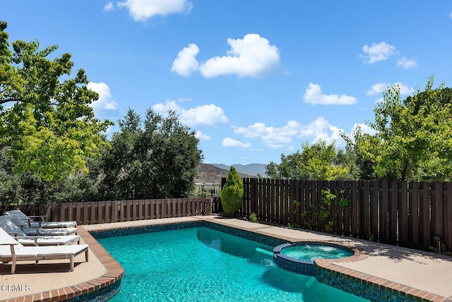 18845 Braemore Rd, Porter Ranch, CA 91326 - view of pool with a pool with connected hot tub and a fenced backyard