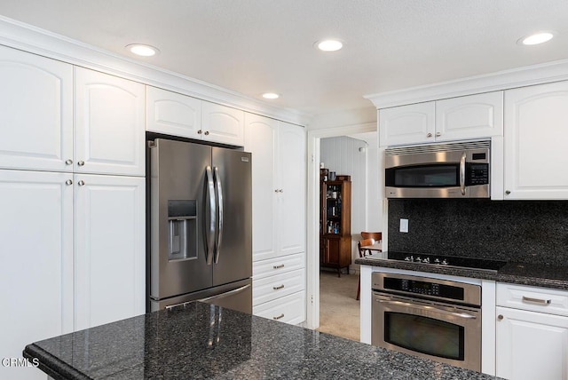 18845 Braemore Rd, Porter Ranch, CA 91326 - kitchen featuring appliances with stainless steel finishes, dark stone countertops, white cabinets, and recessed lighting