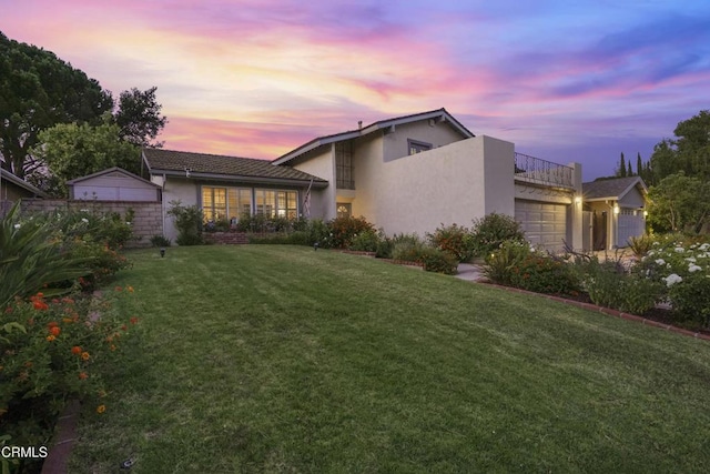 18845 Braemore Rd, Porter Ranch, CA 91326 - view of front of property with stucco siding, an attached garage, a balcony, and a front lawn