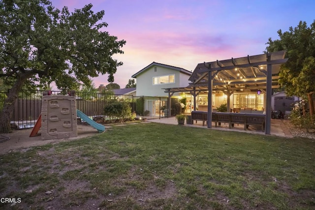 18845 Braemore Rd, Porter Ranch, CA 91326 - yard at dusk featuring a pergola, a patio, and a playground