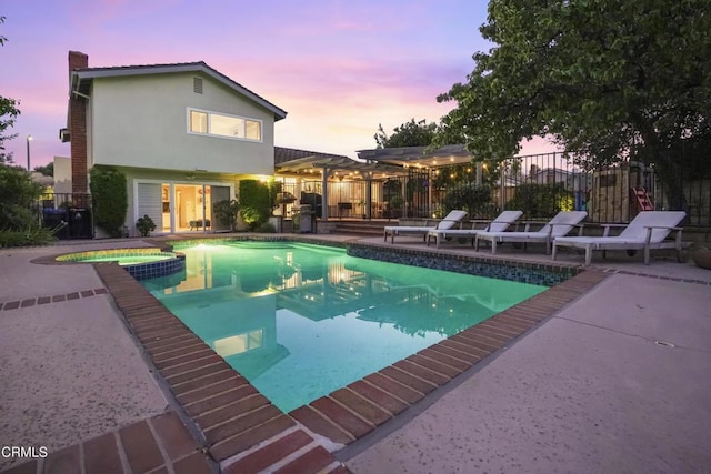 18845 Braemore Rd, Porter Ranch, CA 91326 - pool at dusk featuring a patio and a pool with connected hot tub