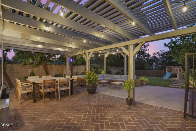 18845 Braemore Rd, Porter Ranch, CA 91326 - patio terrace at dusk featuring a fenced backyard, a playground, outdoor dining area, an outdoor hangout area, and a patio area