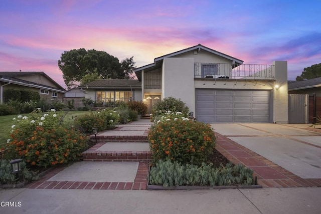 18845 Braemore Rd, Porter Ranch, CA 91326 - view of front of home featuring stucco siding, a balcony, concrete driveway, and a garage