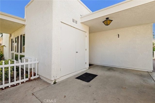 2179 Via Puerta Unit R, Laguna Woods, CA 92637 - property entrance featuring a patio area and stucco siding