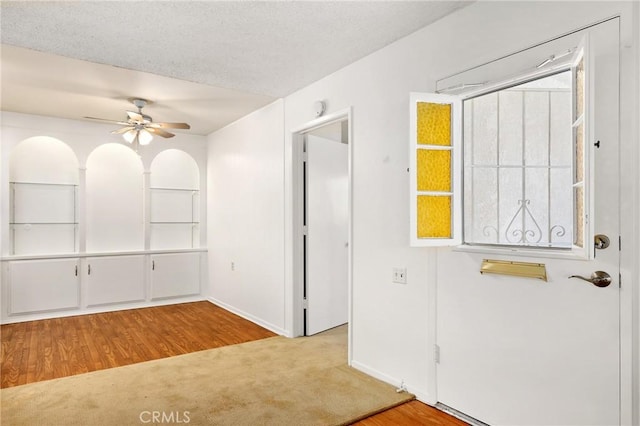 2179 Via Puerta Unit R, Laguna Woods, CA 92637 - foyer entrance featuring a ceiling fan, wood finished floors, and carpet floors