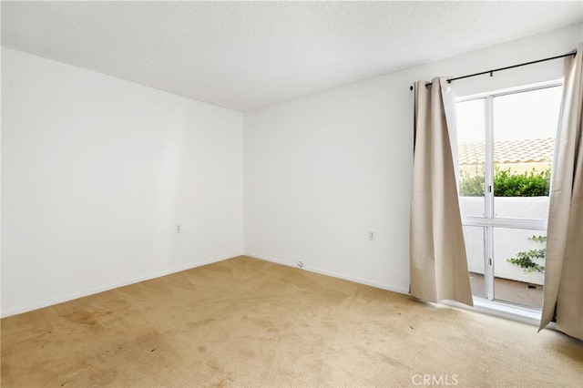 2179 Via Puerta Unit R, Laguna Woods, CA 92637 - empty room featuring light carpet and a textured ceiling