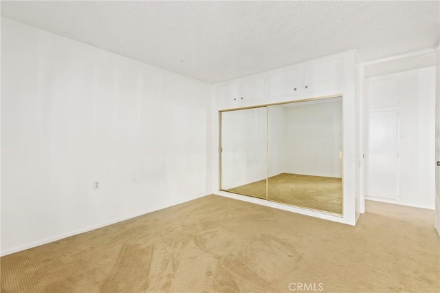 2179 Via Puerta Unit R, Laguna Woods, CA 92637 - unfurnished bedroom with light colored carpet and a closet