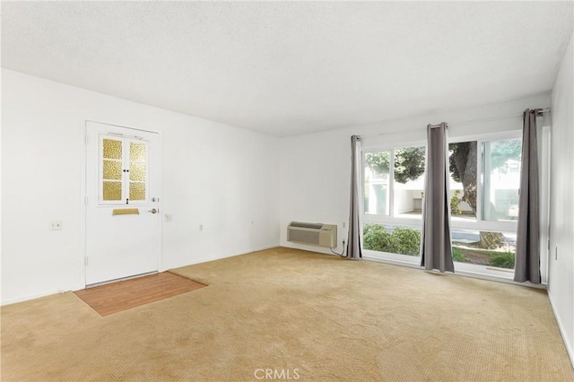2179 Via Puerta Unit R, Laguna Woods, CA 92637 - unfurnished living room featuring a wall mounted air conditioner and carpet floors