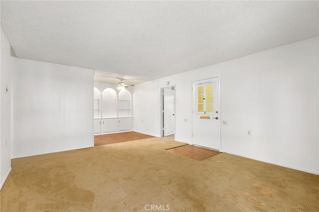 2179 Via Puerta Unit R, Laguna Woods, CA 92637 - unfurnished living room featuring carpet flooring and ceiling fan