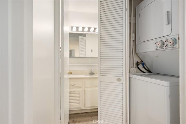 2179 Via Puerta Unit R, Laguna Woods, CA 92637 - washroom with stacked washer / dryer and wood finished floors