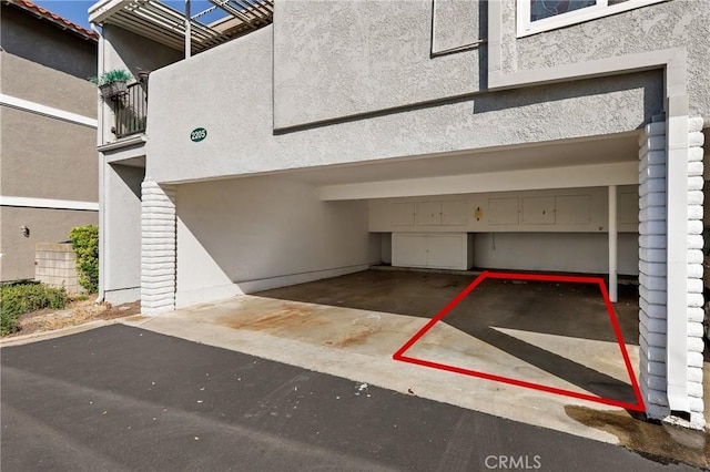 2179 Via Puerta Unit R, Laguna Woods, CA 92637 - view of car parking featuring an attached garage