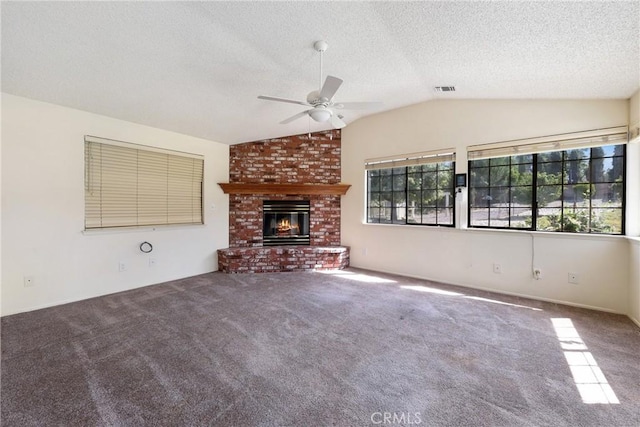 35632 Avocado St, Yucaipa, CA 92399 - unfurnished living room featuring a ceiling fan, lofted ceiling, a fireplace, a textured ceiling, and carpet floors