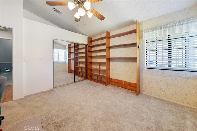 35632 Avocado St, Yucaipa, CA 92399 - unfurnished bedroom with carpet flooring, wallpapered walls, a ceiling fan, a textured ceiling, and vaulted ceiling