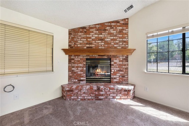 35632 Avocado St, Yucaipa, CA 92399 - unfurnished living room with vaulted ceiling, carpet floors, a textured ceiling, and a brick fireplace