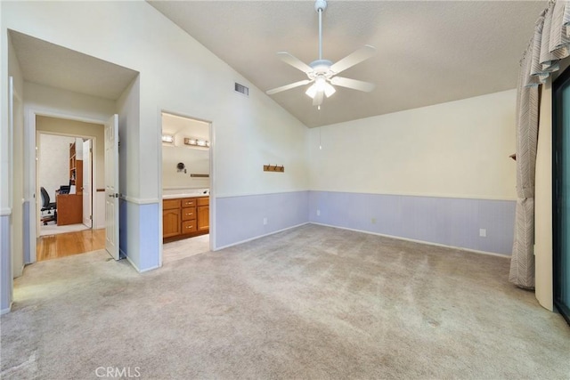 35632 Avocado St, Yucaipa, CA 92399 - unfurnished bedroom featuring lofted ceiling, light carpet, connected bathroom, and ceiling fan
