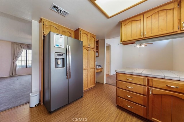 35632 Avocado St, Yucaipa, CA 92399 - kitchen with stainless steel fridge, light wood-style floors, ceiling fan, and tile counters