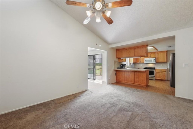 35632 Avocado St, Yucaipa, CA 92399 - kitchen with appliances with stainless steel finishes, a peninsula, open floor plan, ceiling fan, and light carpet