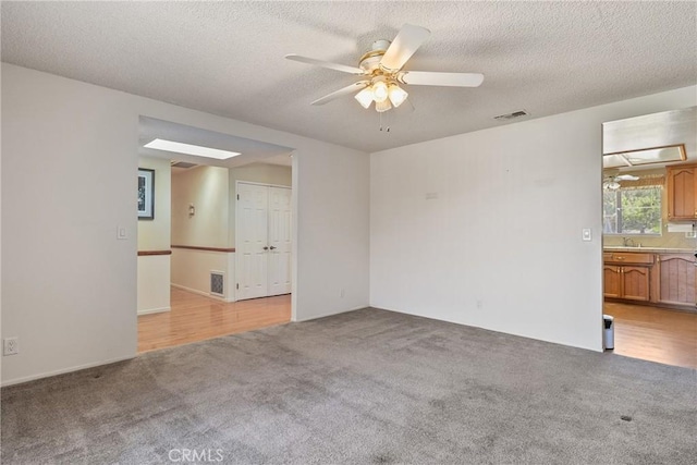 35632 Avocado St, Yucaipa, CA 92399 - spare room featuring light colored carpet, a ceiling fan, and a textured ceiling