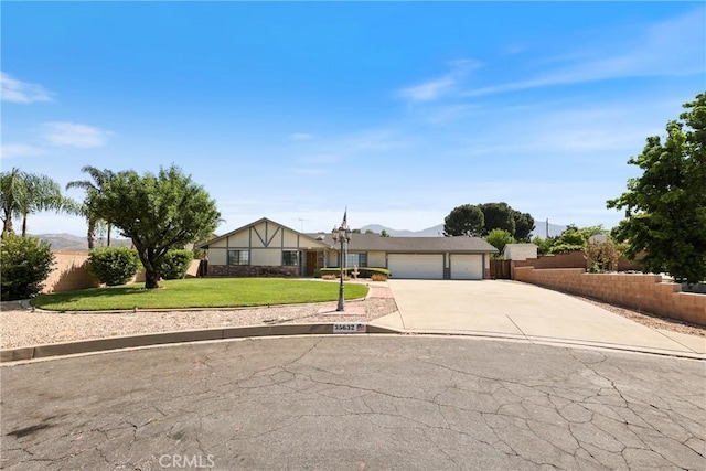 35632 Avocado St, Yucaipa, CA 92399 - view of front of house with concrete driveway, a garage, and a mountain view