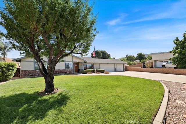 35632 Avocado St, Yucaipa, CA 92399 - ranch-style house featuring driveway, a garage, and a front lawn