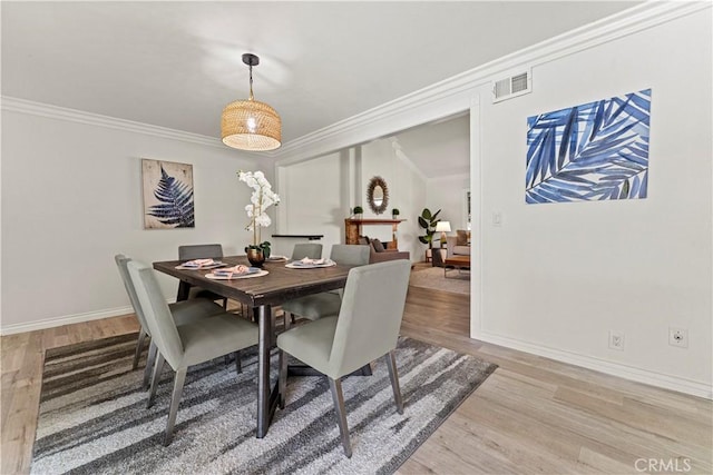 1626 Birchfield Dr, Tustin, CA 92780 - dining area featuring ornamental molding and light wood finished floors
