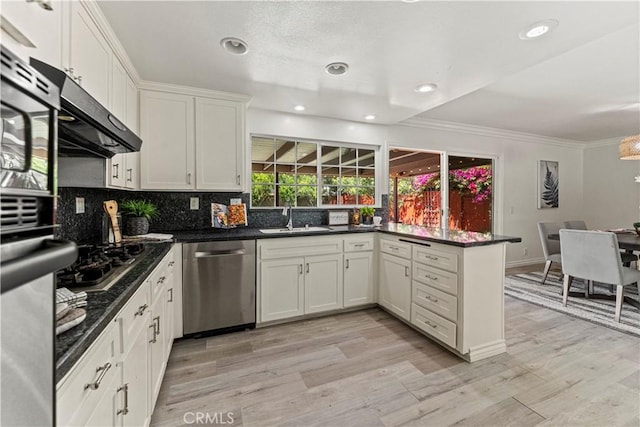 1626 Birchfield Dr, Tustin, CA 92780 - kitchen with stainless steel appliances, a peninsula, crown molding, white cabinets, and light wood finished floors