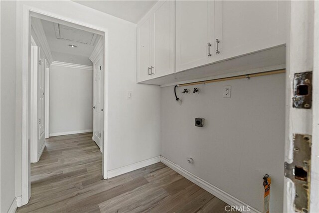 1626 Birchfield Dr, Tustin, CA 92780 - washroom featuring cabinet space, crown molding, washer hookup, hookup for an electric dryer, and wood finished floors