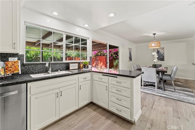 1626 Birchfield Dr, Tustin, CA 92780 - kitchen featuring stainless steel dishwasher, light wood finished floors, white cabinets, backsplash, and ornamental molding