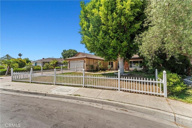 1626 Birchfield Dr, Tustin, CA 92780 - view of front of property with a fenced front yard, an attached garage, and concrete driveway
