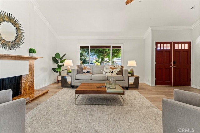 1626 Birchfield Dr, Tustin, CA 92780 - living room featuring wood finished floors, ornamental molding, a high end fireplace, and ceiling fan