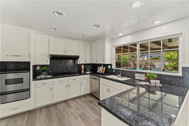 1626 Birchfield Dr, Tustin, CA 92780 - kitchen featuring appliances with stainless steel finishes, a warming drawer, under cabinet range hood, white cabinets, and recessed lighting
