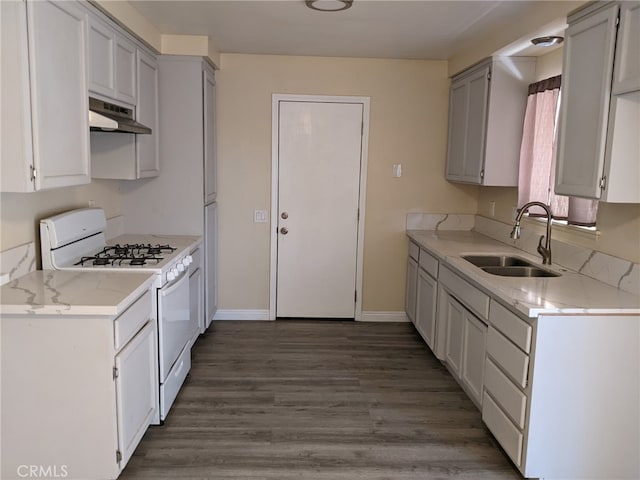18605 New Hampshire St, Adelanto, CA 92301 - kitchen with white gas range, under cabinet range hood, wood finished floors, gray cabinetry, and light stone countertops