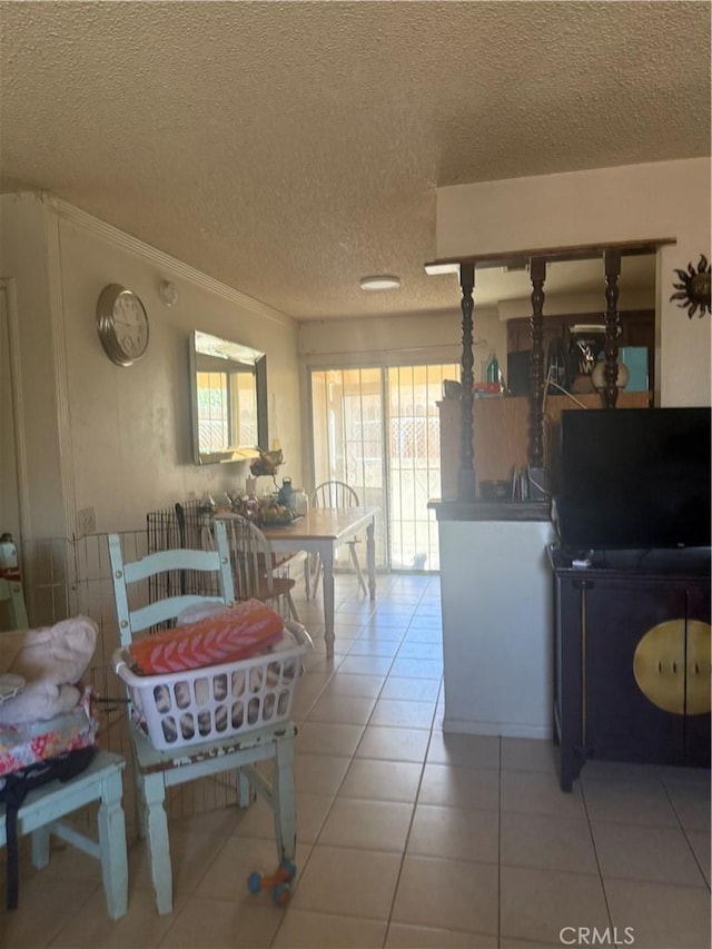 18605 New Hampshire St, Adelanto, CA 92301 - dining room featuring light tile patterned flooring, a textured ceiling, and ornamental molding