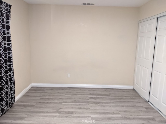 18605 New Hampshire St, Adelanto, CA 92301 - unfurnished bedroom featuring light wood-type flooring and a closet