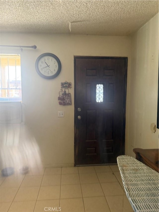18605 New Hampshire St, Adelanto, CA 92301 - entrance foyer with a textured ceiling, healthy amount of natural light, and tile patterned floors