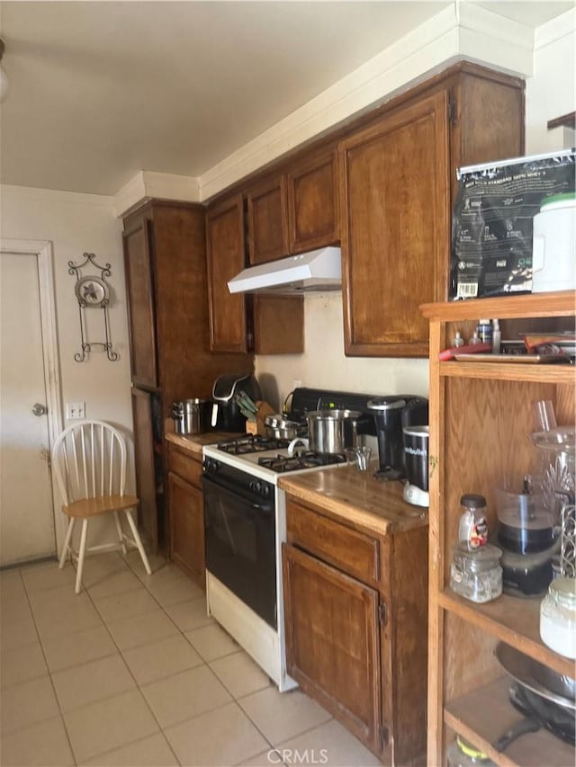18605 New Hampshire St, Adelanto, CA 92301 - kitchen featuring under cabinet range hood, white gas range, and light tile patterned floors