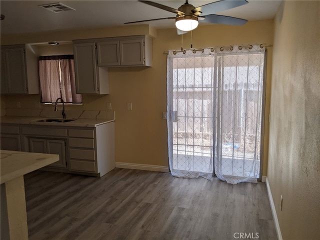 18605 New Hampshire St, Adelanto, CA 92301 - kitchen featuring ceiling fan, light countertops, wood finished floors, and plenty of natural light