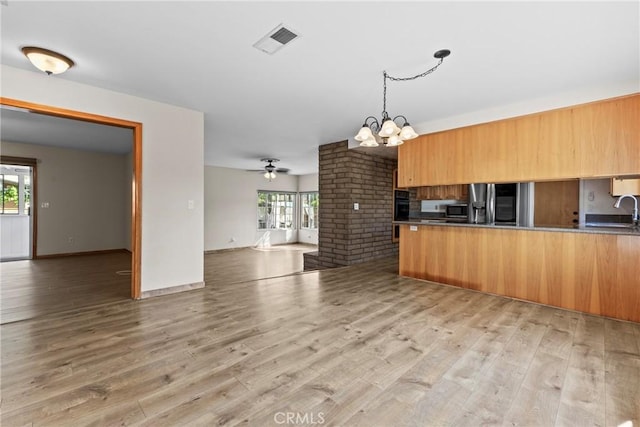 8609 Dunwoodie Rd, Santee, CA 92071 - kitchen featuring open floor plan, a chandelier, appliances with stainless steel finishes, and healthy amount of natural light