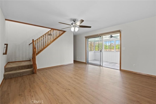 8609 Dunwoodie Rd, Santee, CA 92071 - unfurnished living room featuring wood finished floors, ceiling fan, and stairway