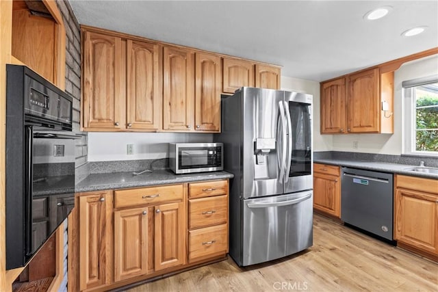 8609 Dunwoodie Rd, Santee, CA 92071 - kitchen with appliances with stainless steel finishes, light wood-type flooring, dark countertops, recessed lighting, and brown cabinets