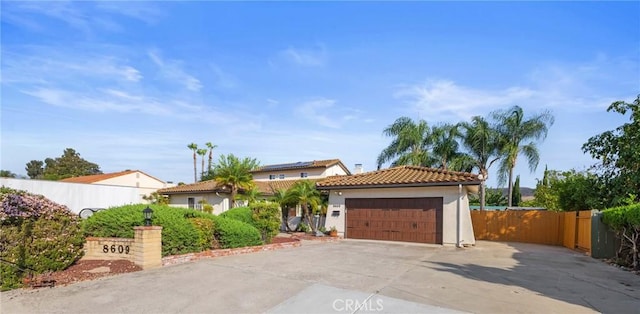 8609 Dunwoodie Rd, Santee, CA 92071 - mediterranean / spanish house featuring a garage, a tile roof, driveway, and stucco siding