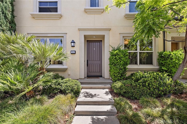 55 Jade Flower, Irvine, CA 92620 - doorway to property featuring stucco siding